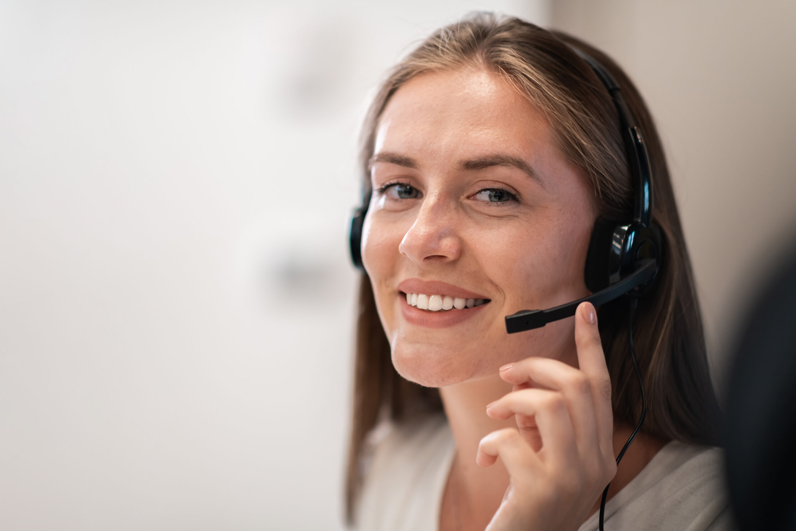 Woman answering the telephone at Smart and Simple Communications