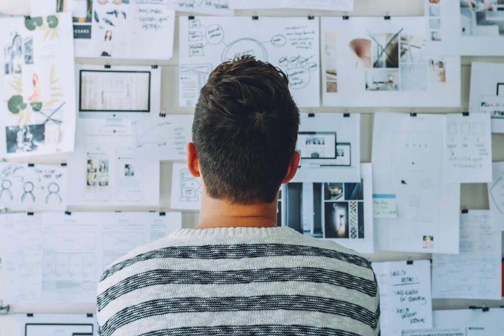 Man looking at a whiteboard contemplating growth.