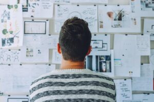 Man looking at a whiteboard contemplating growth.