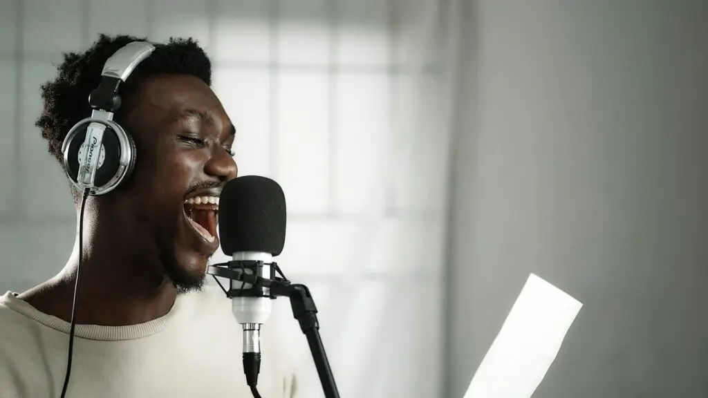 Vocalist in headphones recording a custom jingle in a studio, reading from a script, for a local radio and digital ad campaign