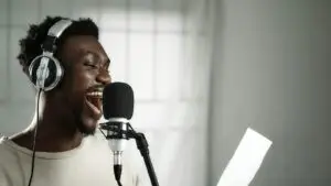 Vocalist in headphones recording a custom jingle in a studio, reading from a script, for a local radio and digital ad campaign