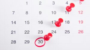 how-long-does-it-take-to-build-a-website - Smart & Simple Communications - Smart & Simple Communications Wall calendar with red pins marking milestone dates and a circled deadline, the kind of build schedule Smart & Simple Communications maps out for a Branson small business website.